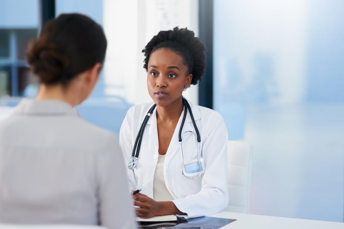 doctor talking to female patient